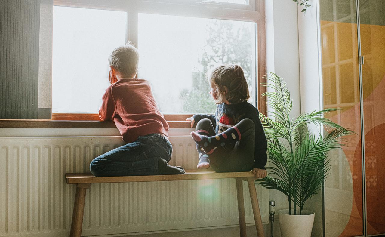 Two kids at a radiator